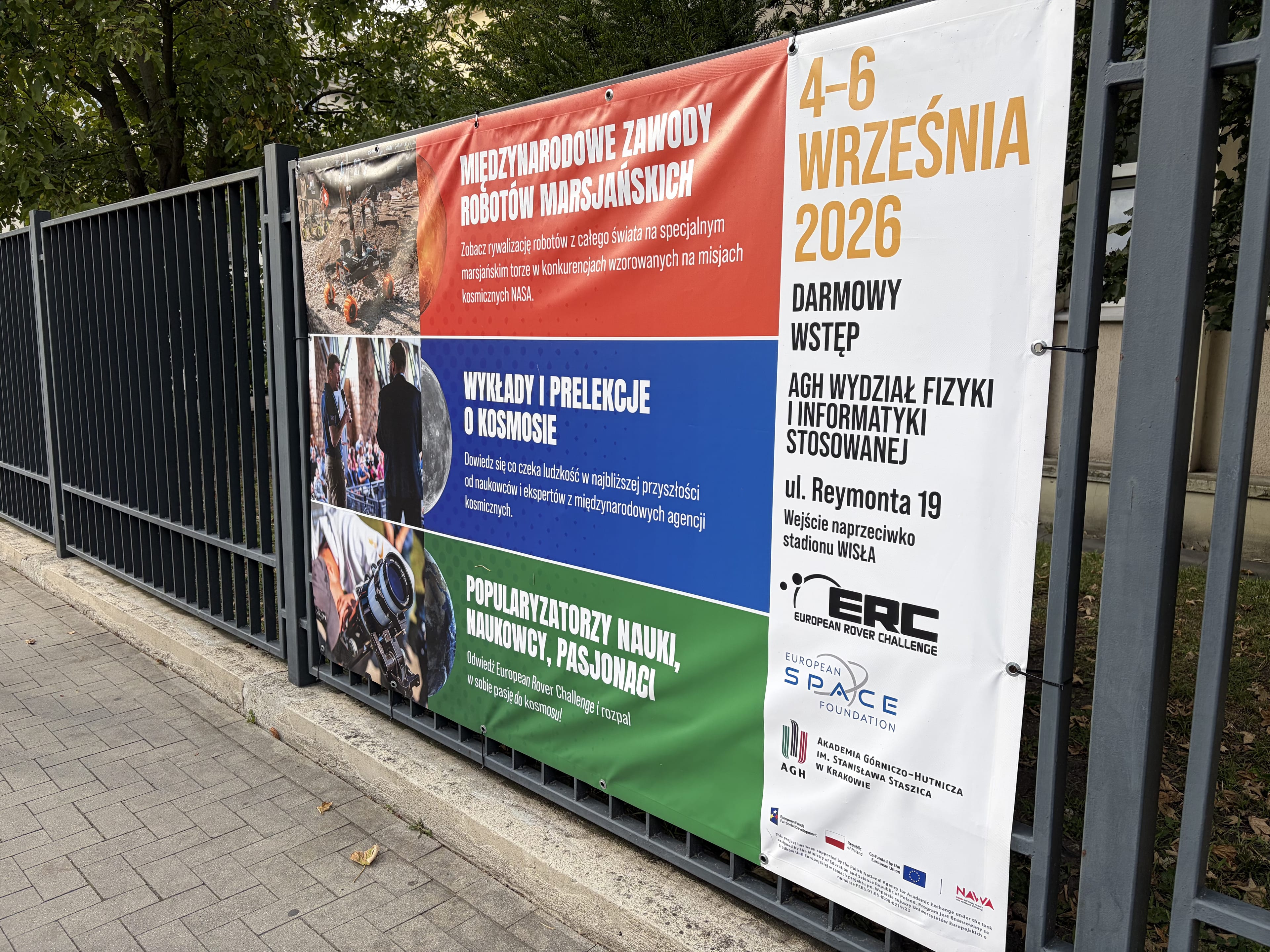 The ERC 2026 banner on the AGH fence announces the event dates in Kraków.