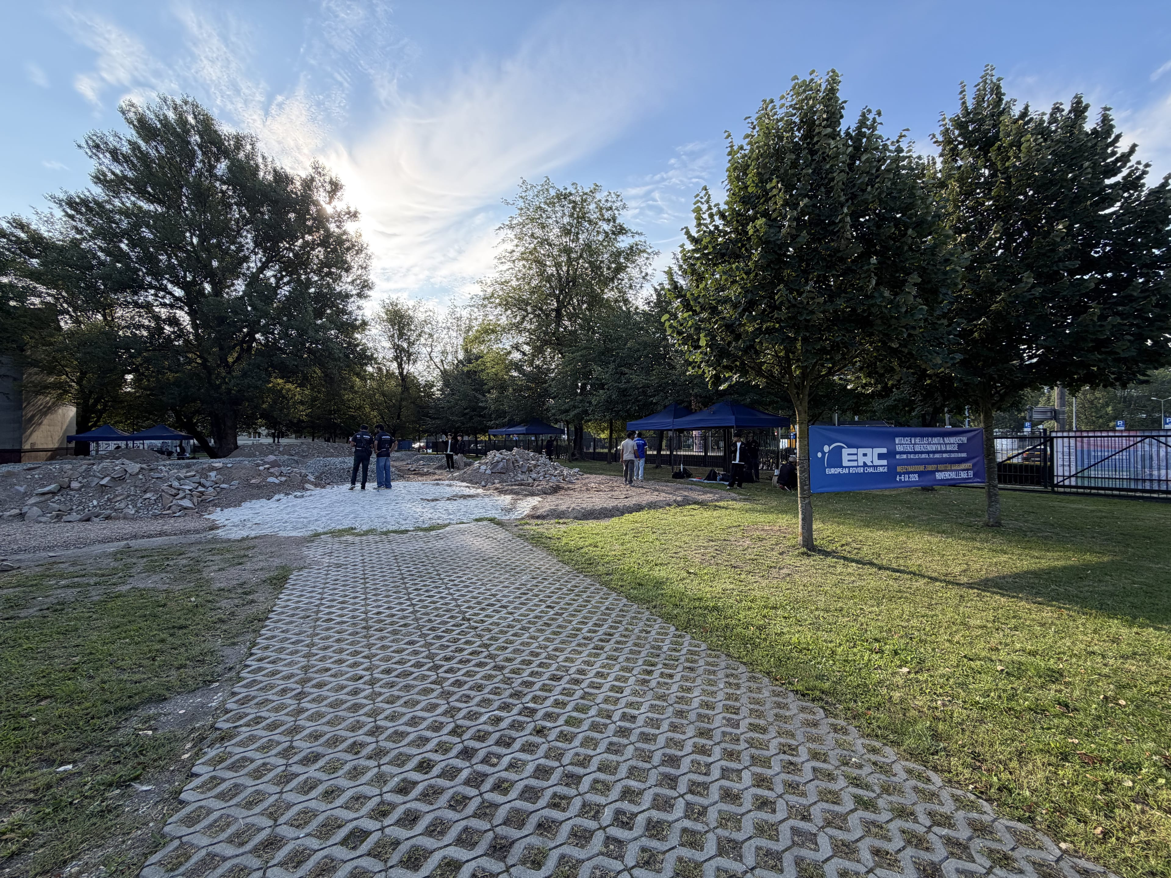 Morning light falls on the Mars yard, the ERC banner and the blue pit tents before the first runs.