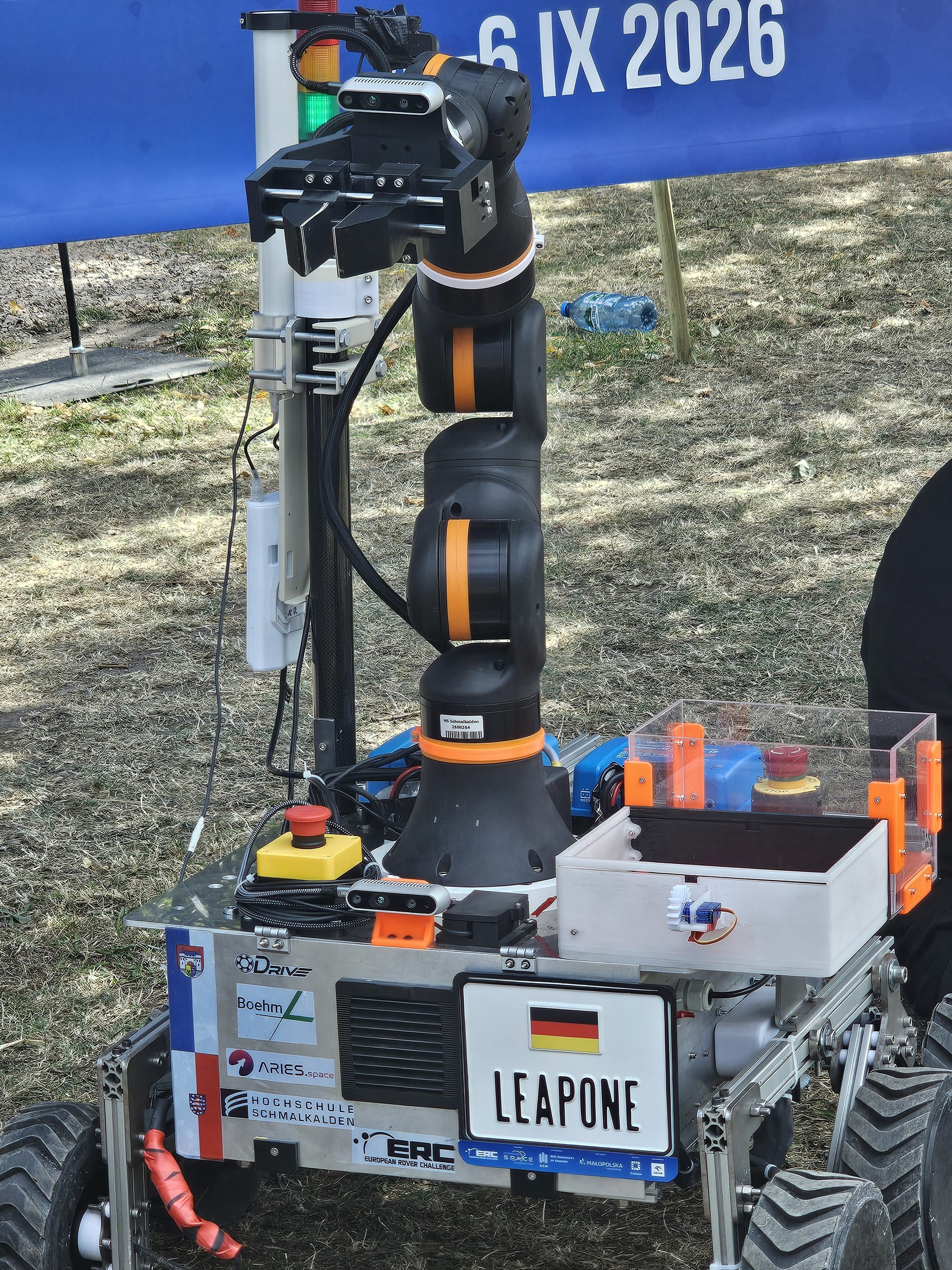 LEAP-One's arm, sensor mast and sample container in front of the ERC banner.