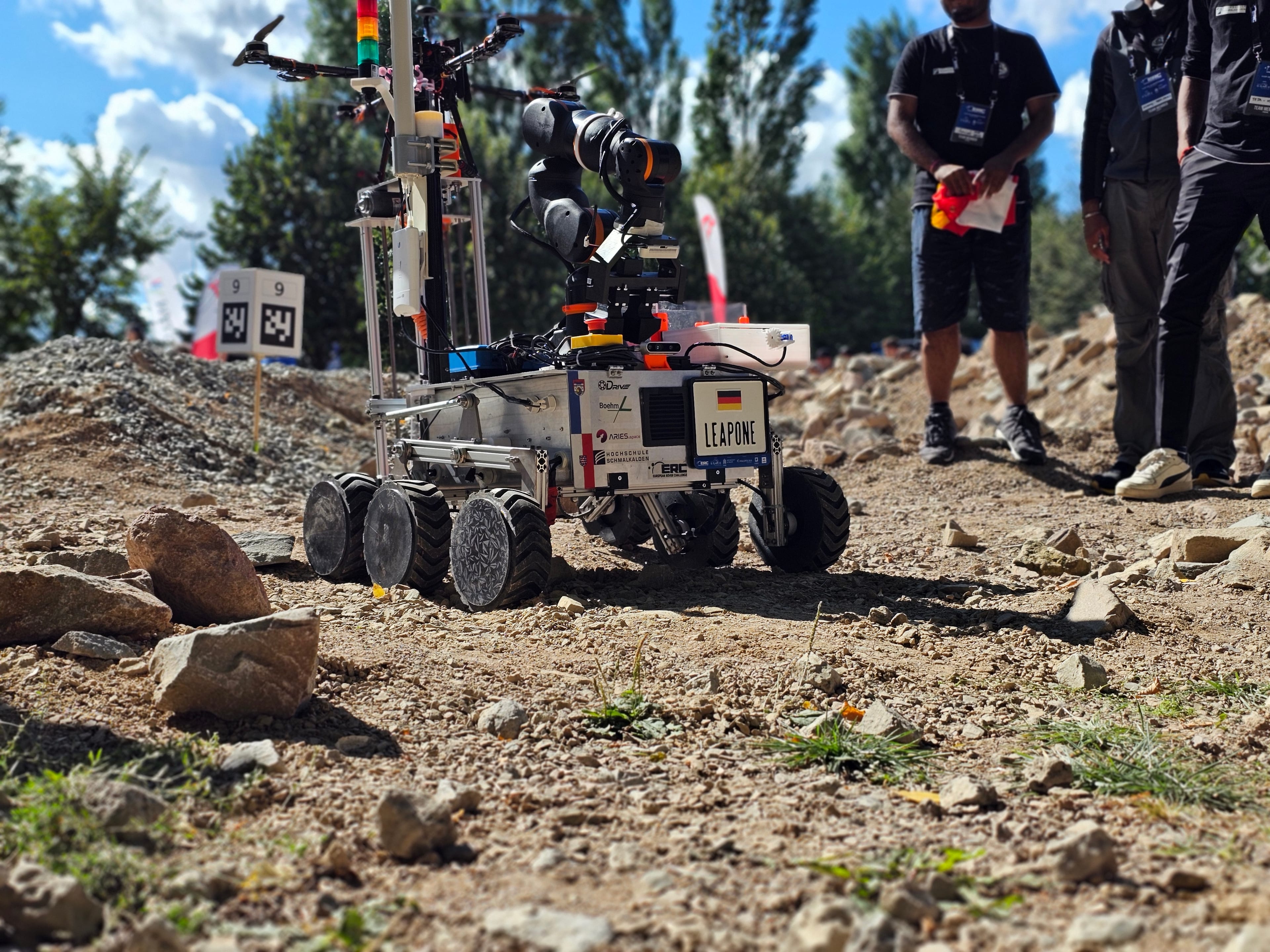 LEAP-One climbs the gravel with the team’s quadcopter riding on its deck.